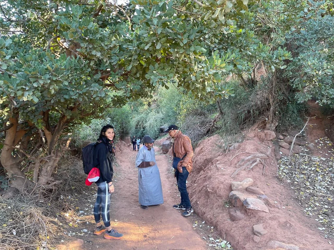 Guest walking with local guide through Zat Valley fields